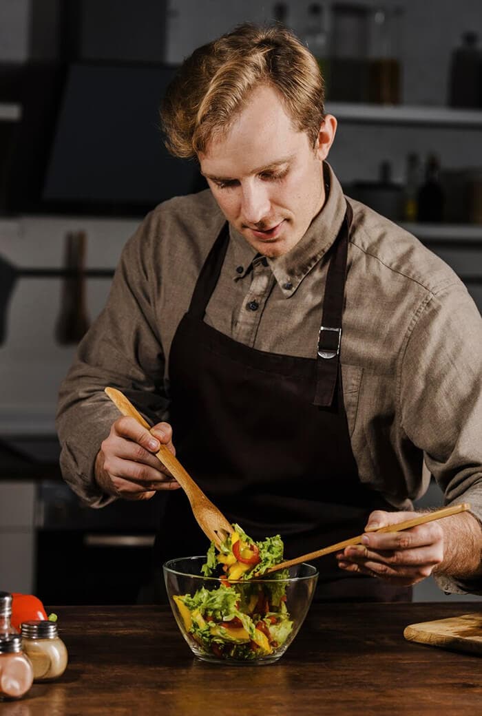 Cook plating a dish in the Vespera kitchen